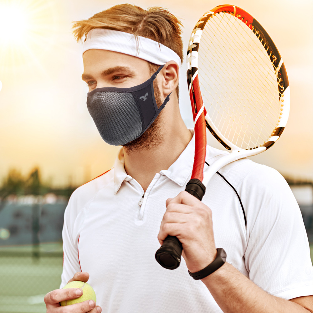 NAROO N0U gray face cover worn by a man holding a tennis racket