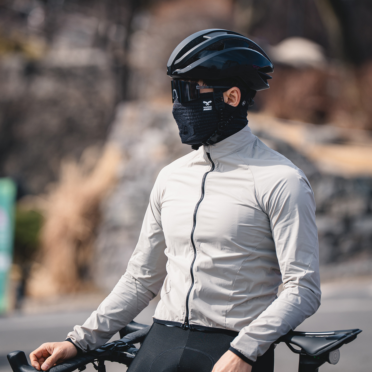 NAROO A1 Pro Smoke Black sports face cover worn beside a bicycle
